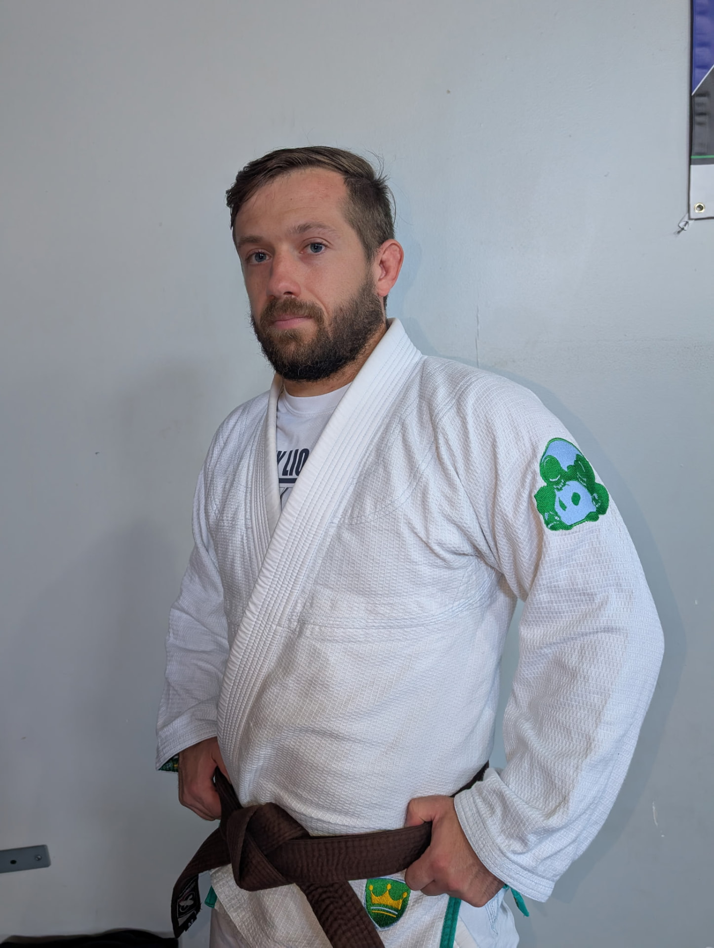 Coach Kodie in a white gi with brown belt